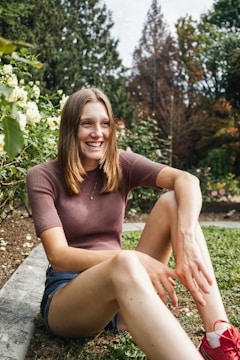 A smiling caregiver engaging with a client in a garden.