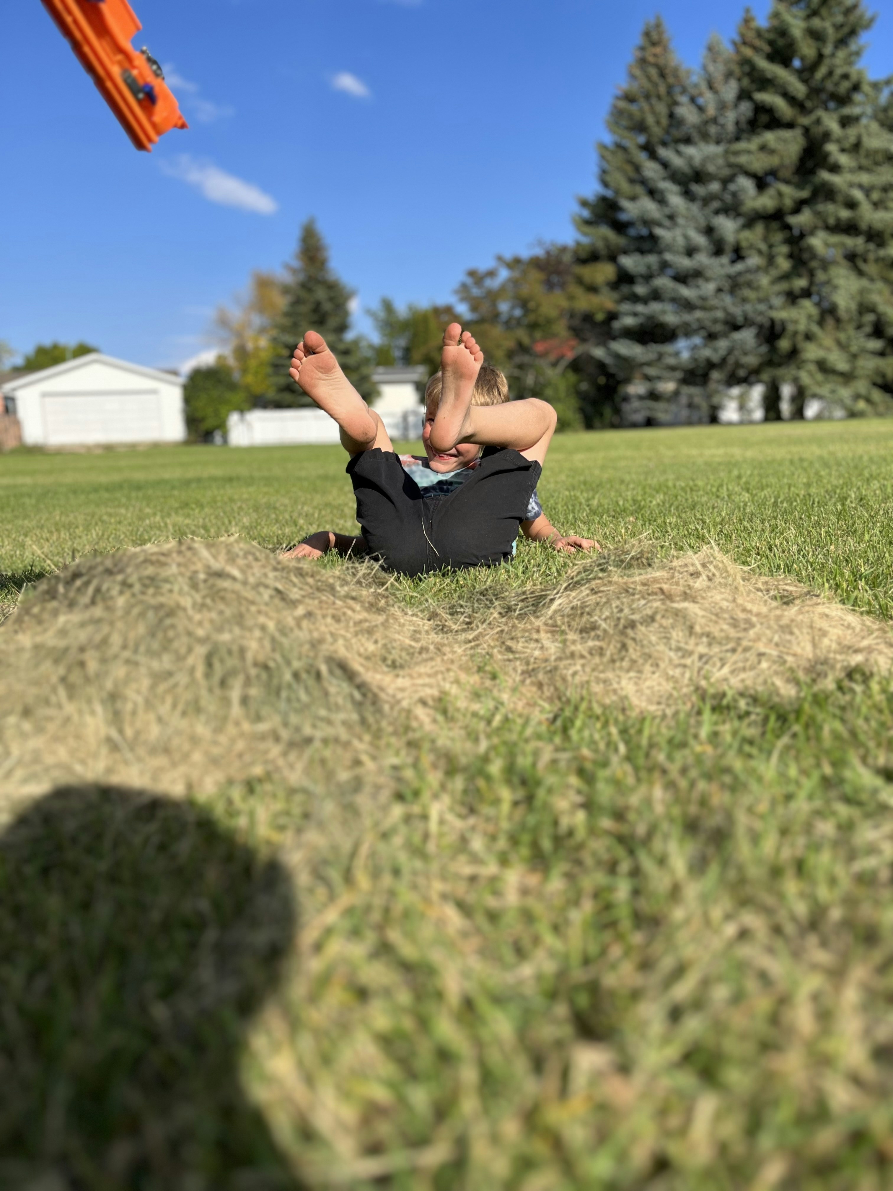 a man laying on the ground in the grass