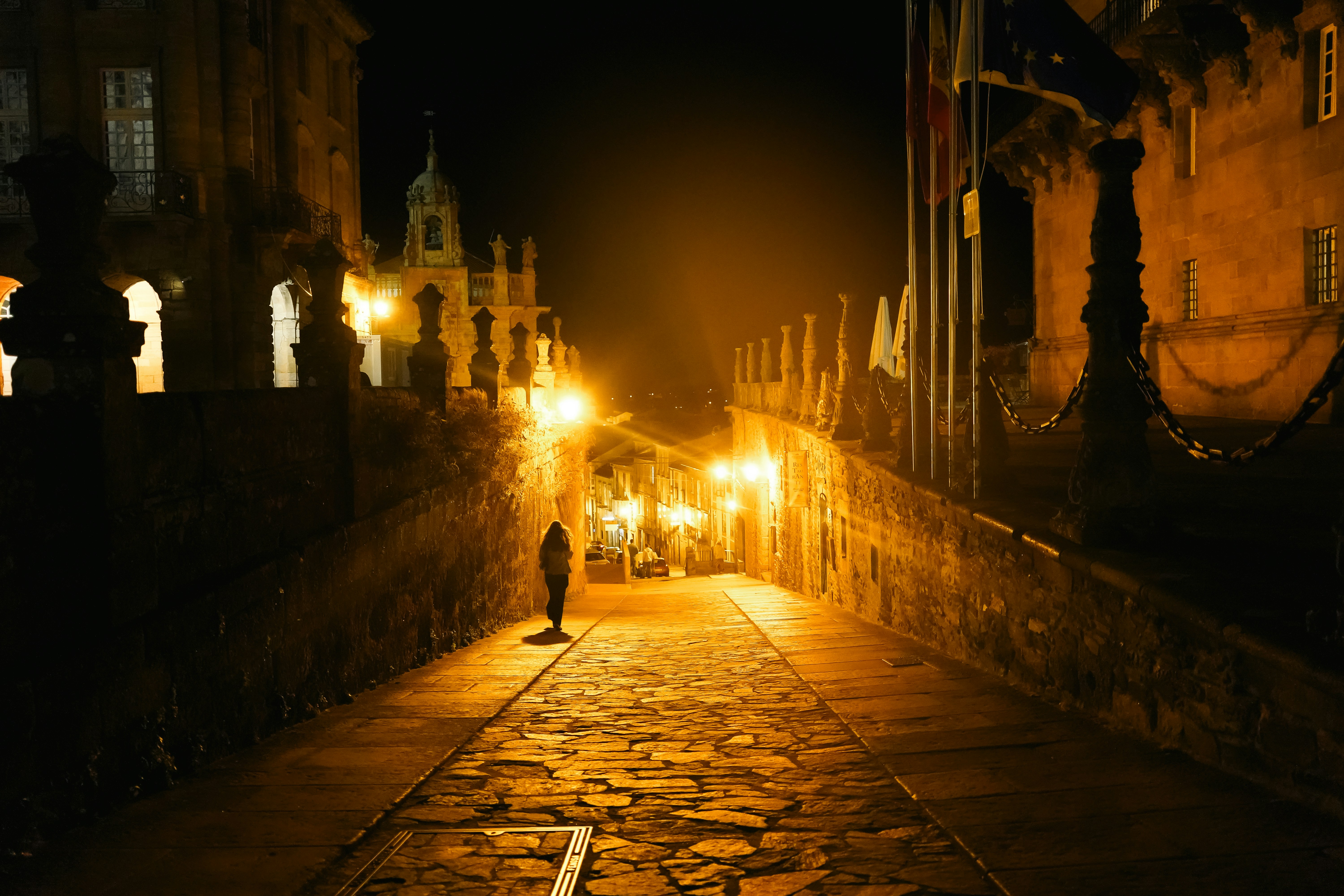 a person walking down a street at night