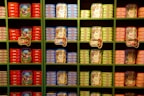Shelves stocked with canned tuna and sardines in a large store.