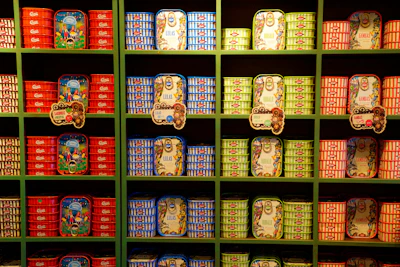 An overhead shot of assorted sardine cans with different flavors arranged neatly.