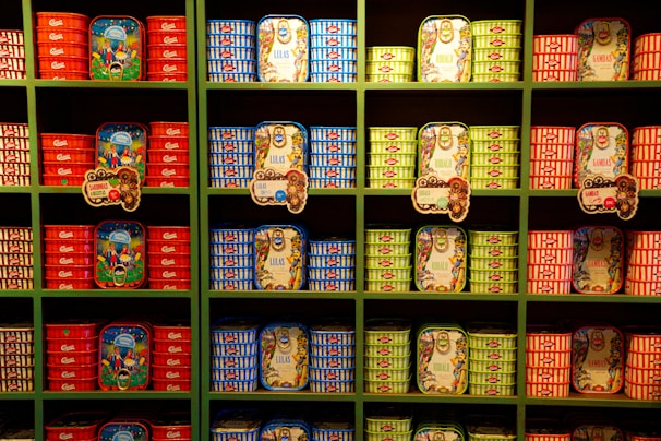 Various bags of fish food arranged neatly on wooden shelves in a cozy store setting