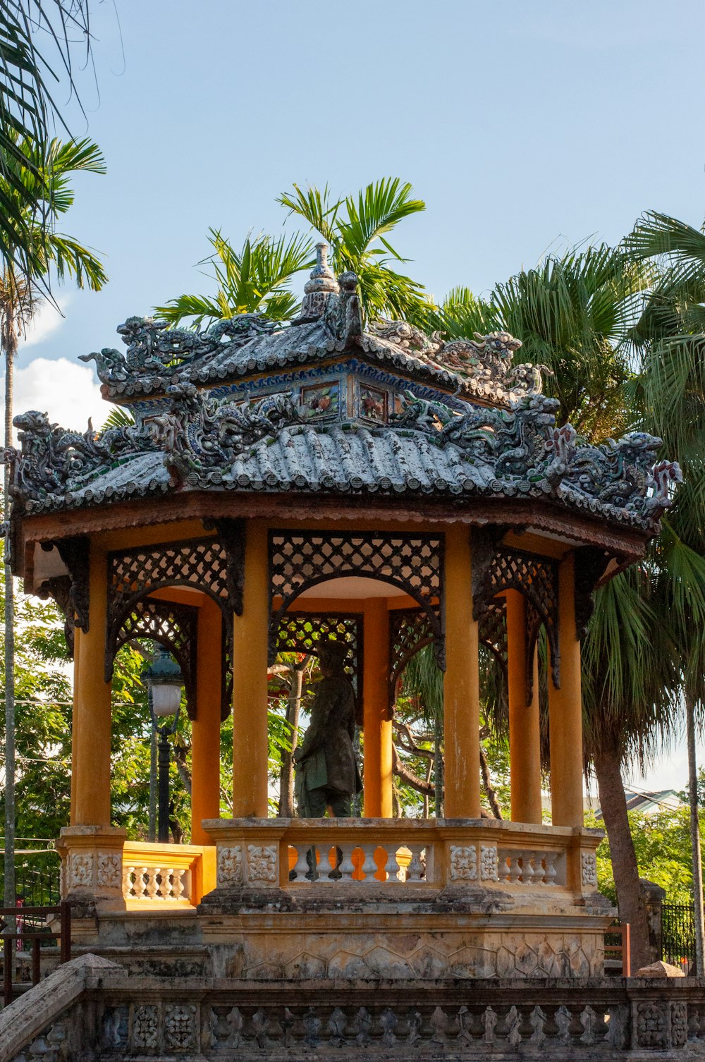 a gazebo with a statue in the middle of it