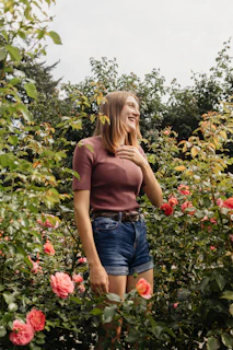 Rosie tending to her plants with a gentle smile, surrounded by blooming flowers.