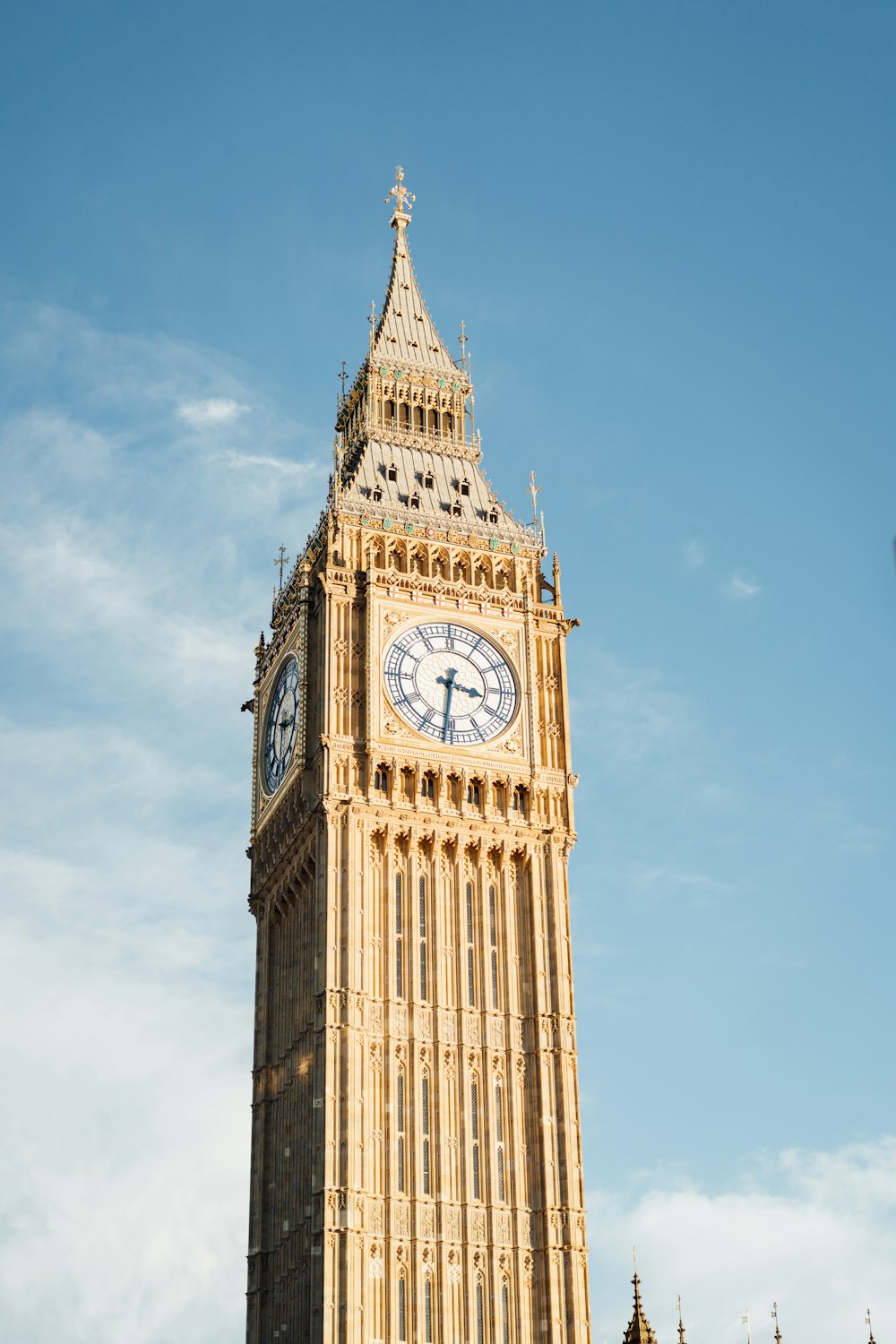 a tall clock tower with a clock on each of it's sides