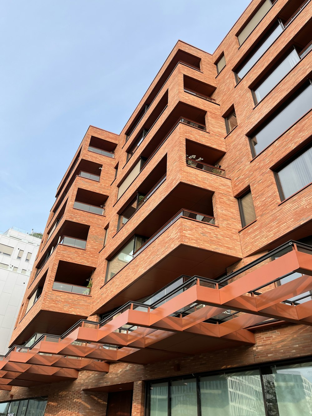 a tall building with lots of balconies on top of it