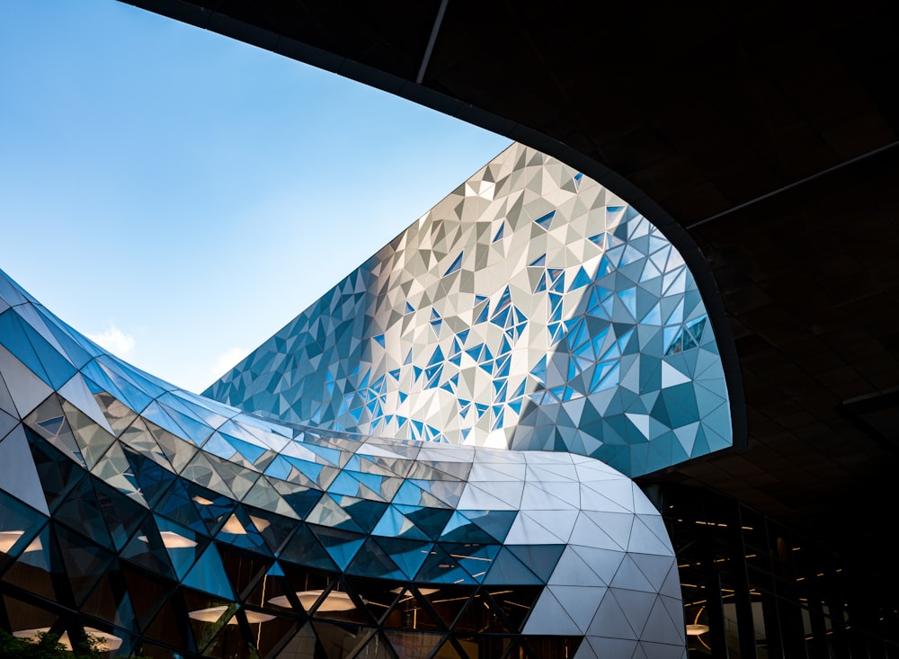 a building with a curved roof and a sky background