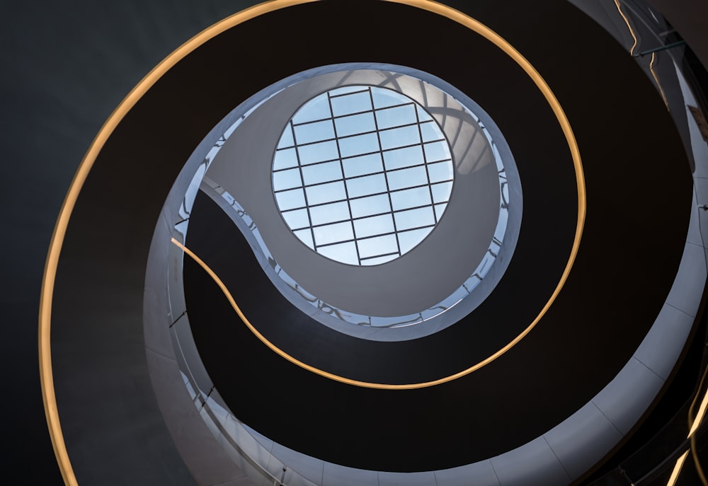 a spiral staircase with a circular window in the center