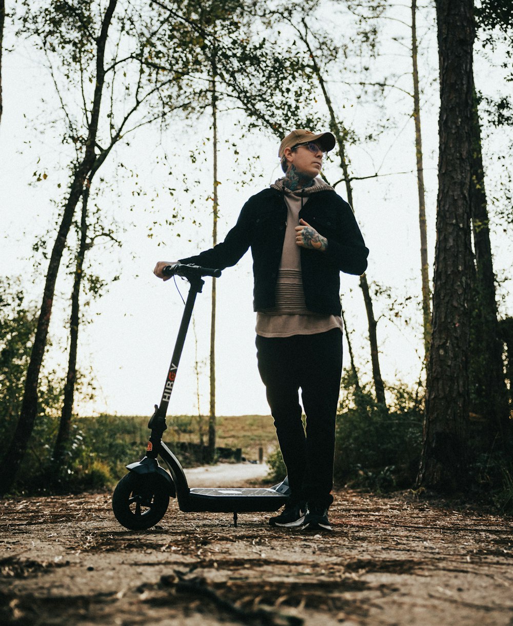 a person standing on a scooter in the woods