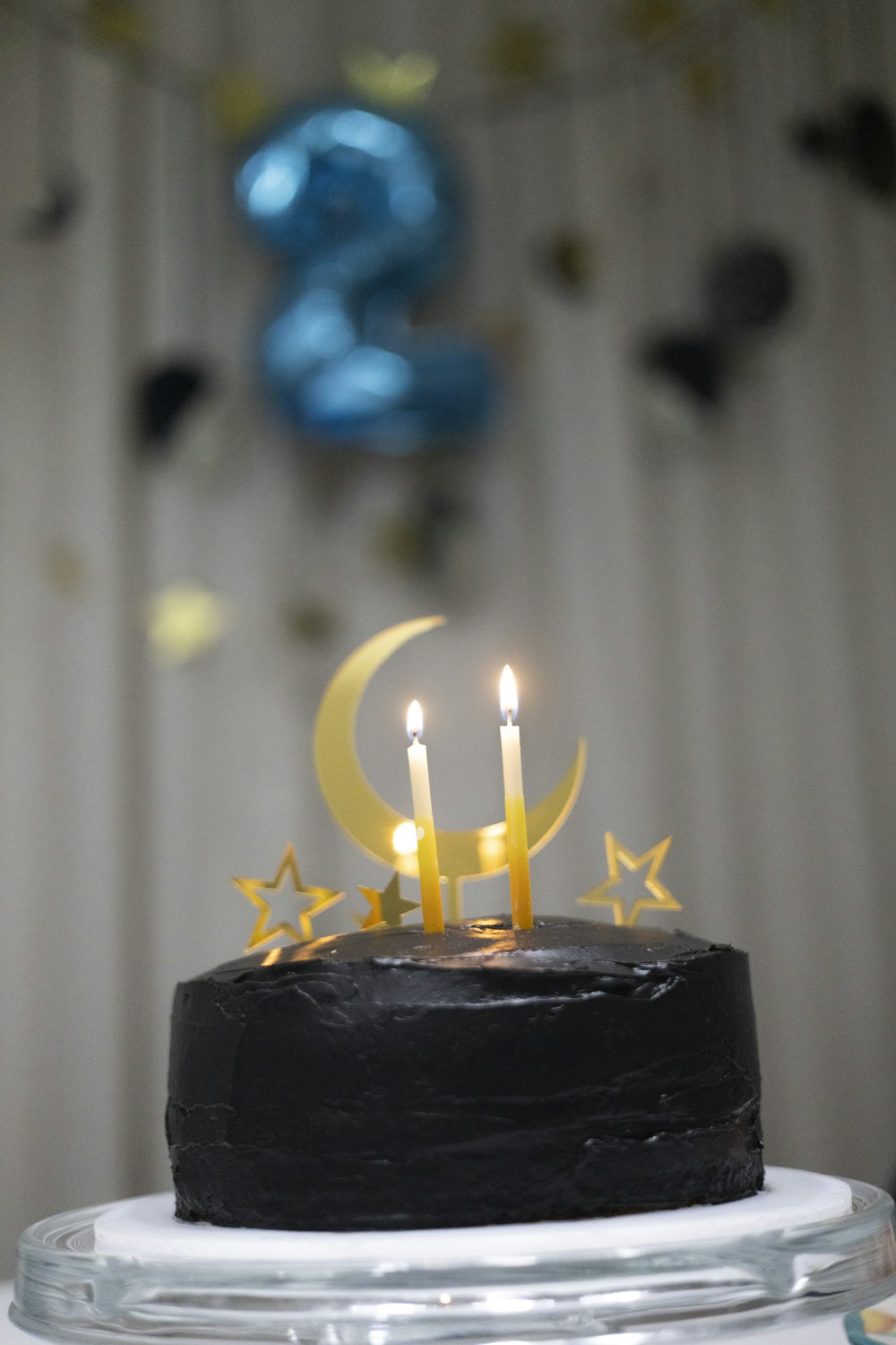 a birthday cake with two candles on top of it