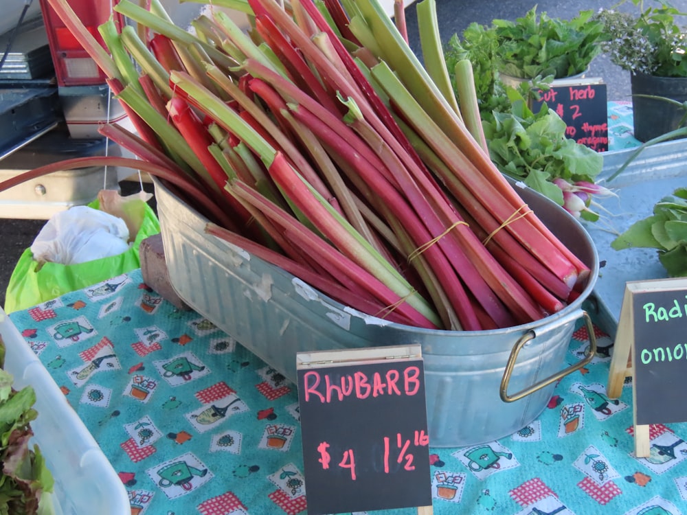 a bucket of rhubarb on a table