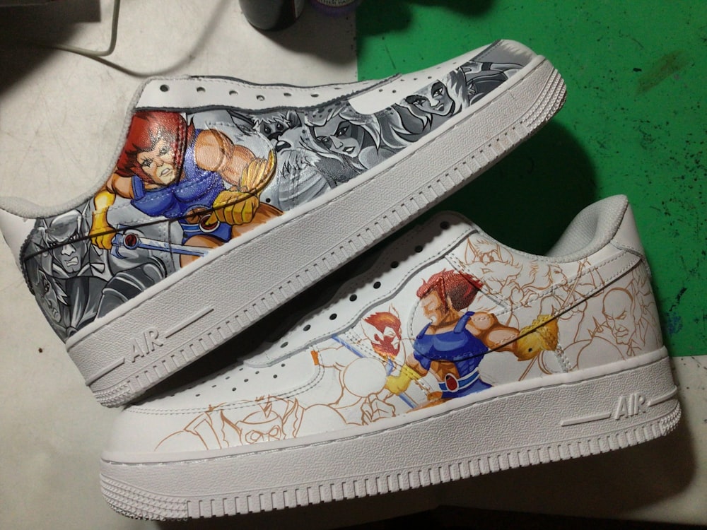 a pair of sneakers with cartoon characters painted on them