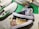 Custom-painted sneakers featuring vibrant anime character designs. The shoes have detailed and colorful illustrations, including elements like waves and various shades, with the artwork skillfully applied on the canvas surface.