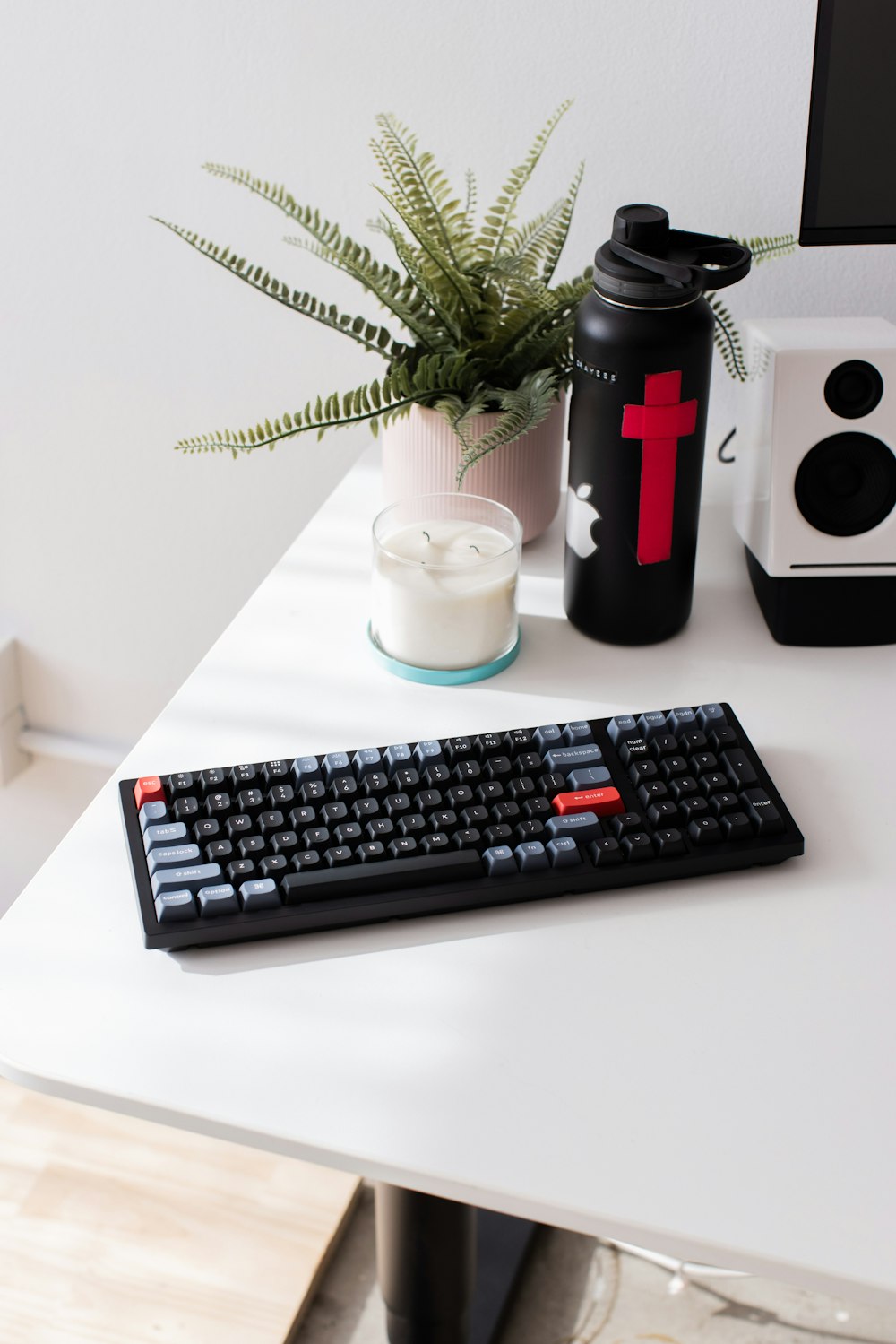 a computer keyboard sitting on top of a white desk