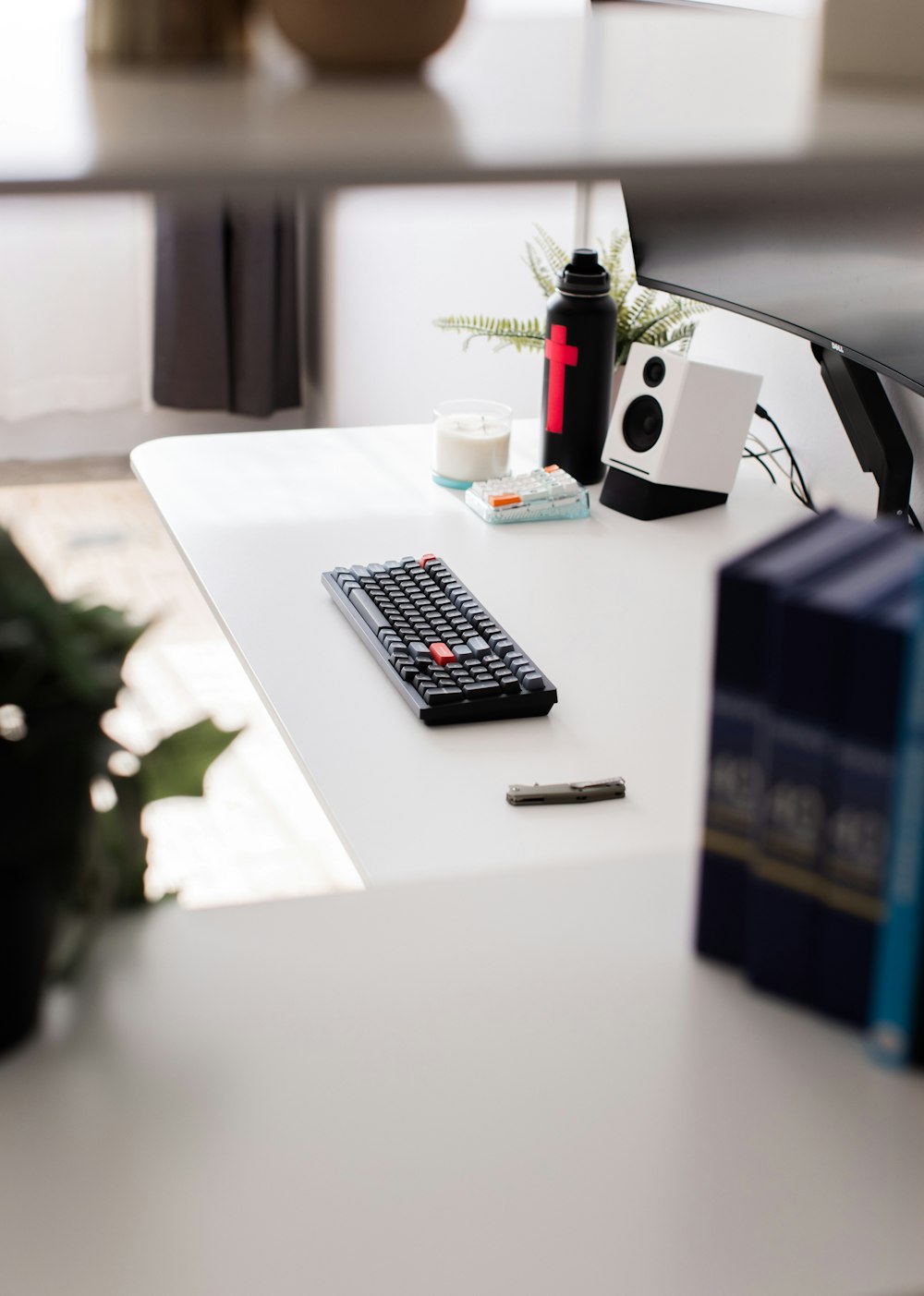a remote control sitting on top of a white desk
