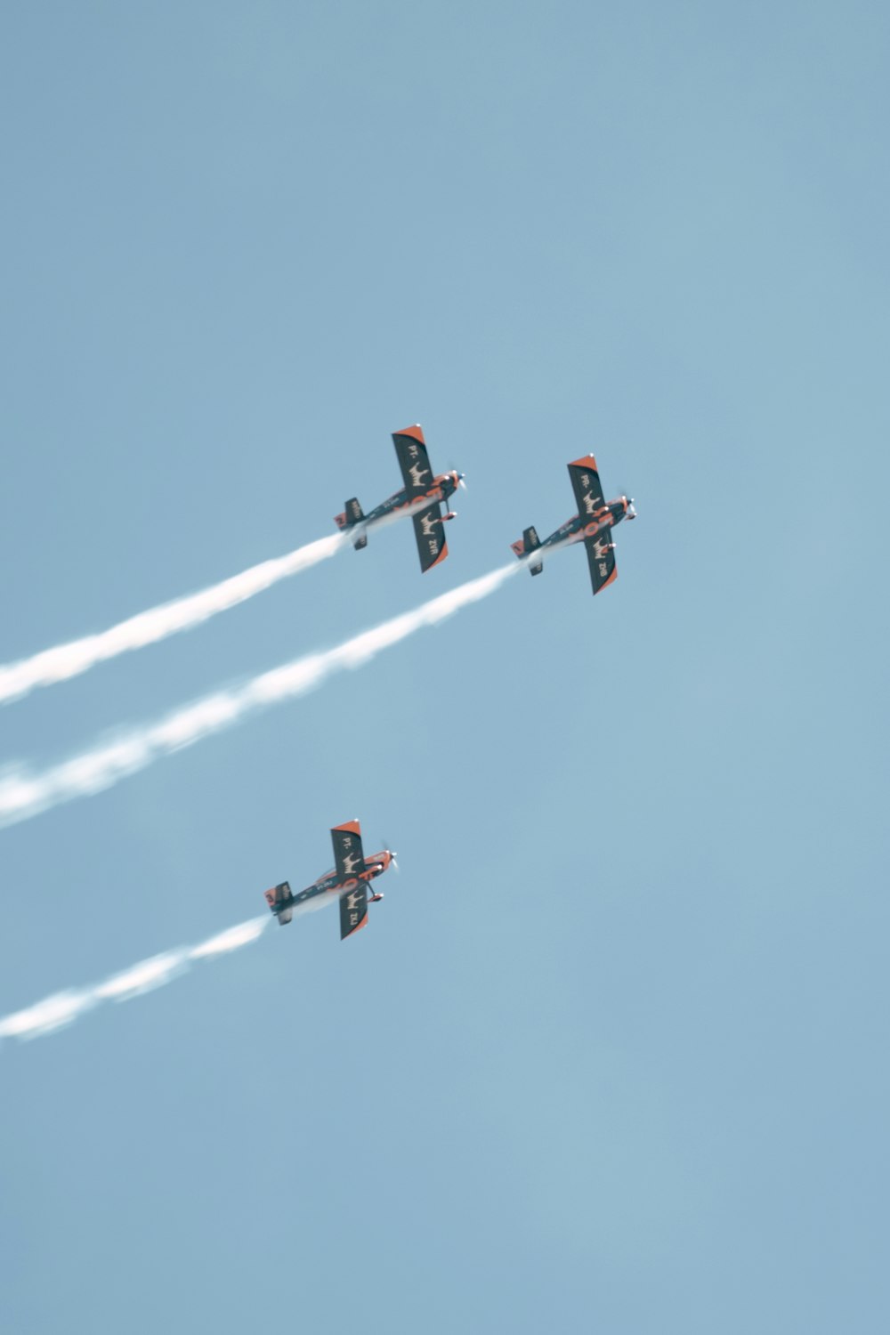 three airplanes are flying in formation in the sky