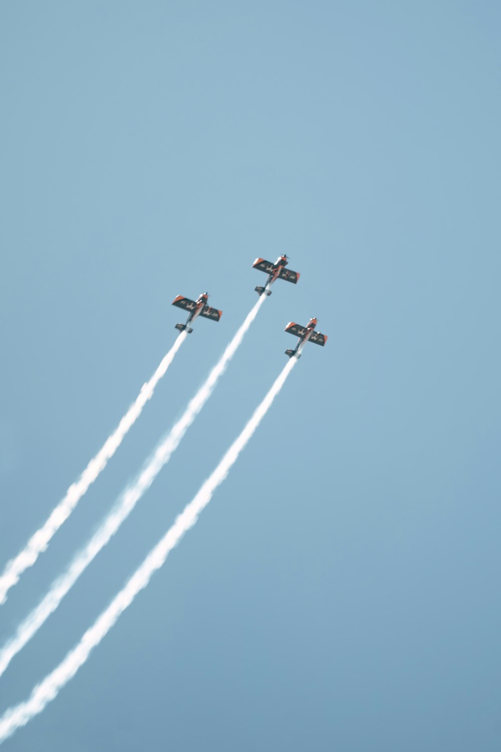 four airplanes flying in formation in the sky