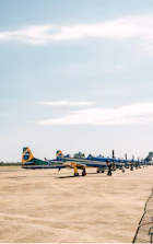 Professional flight line with sleek aircraft parked under a clear blue sky.