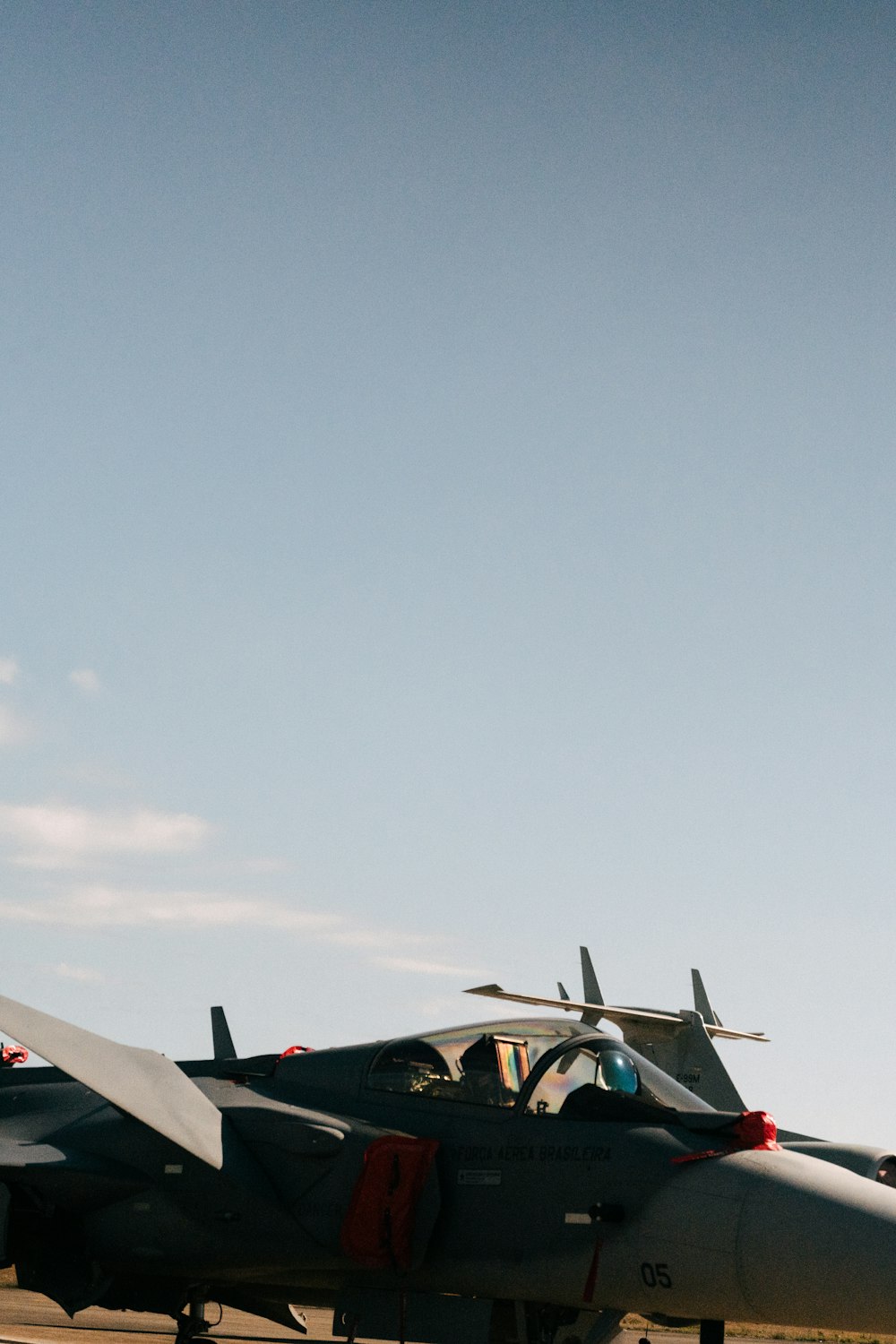 a fighter jet sitting on top of an airport tarmac