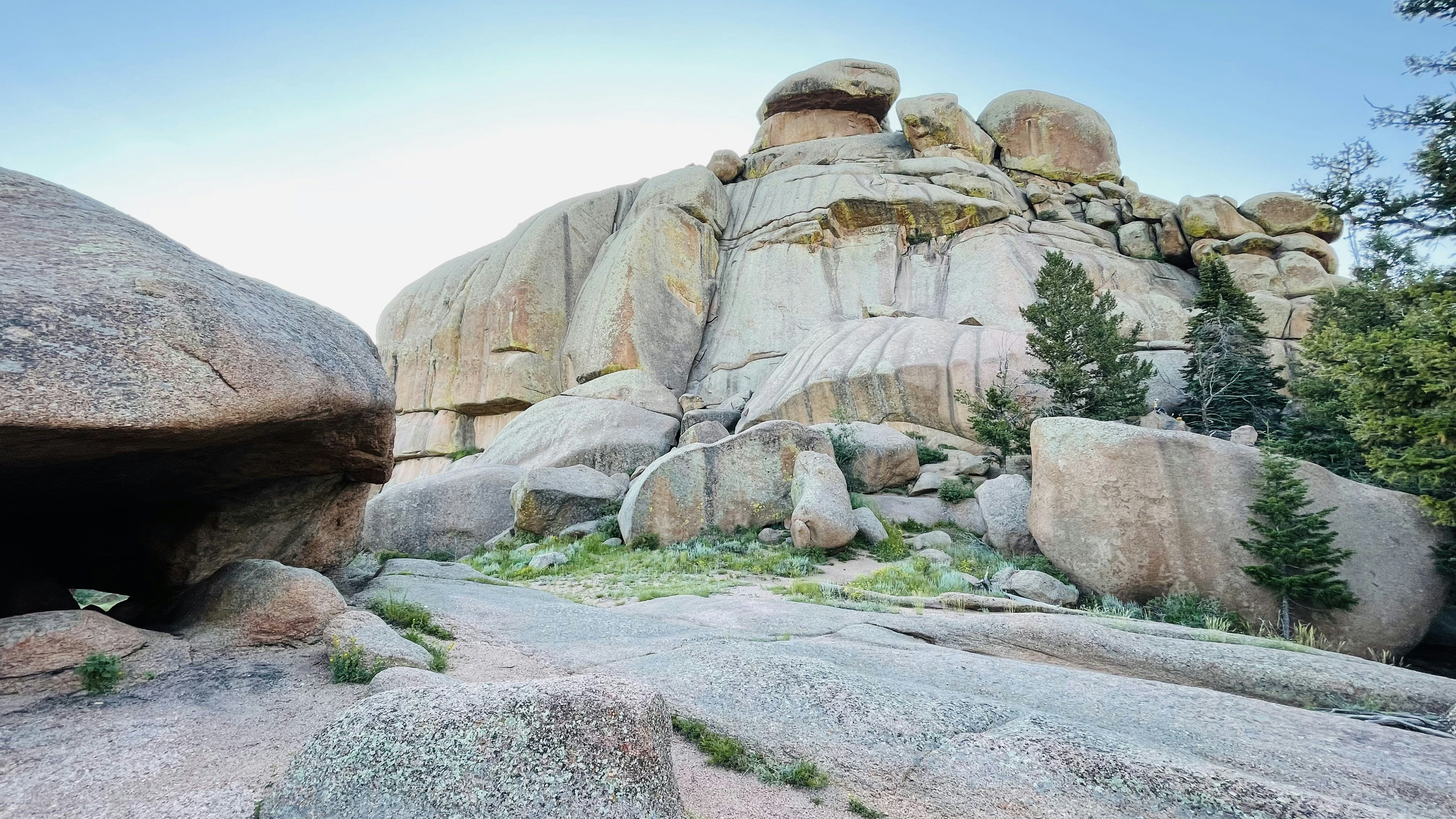 A large rock formation with a cave in the middle of it photo – Free ...