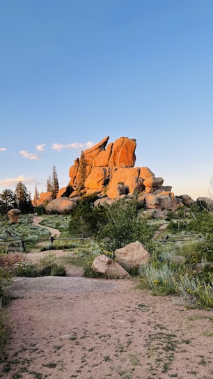 a large rock formation in the middle of a field