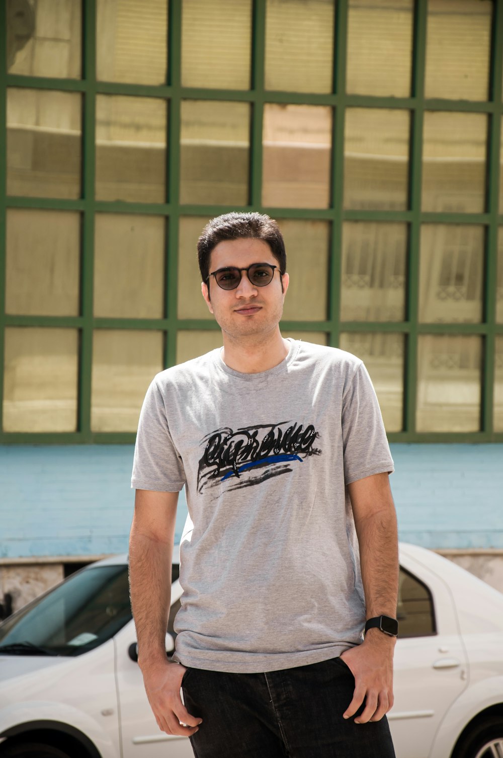 a man standing in front of a white car