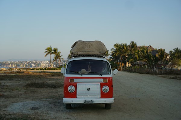 A red and white van parked on a dirt road — Puerto Escondido, Mexico