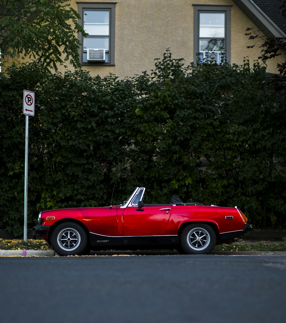 a red sports car parked in front of a house