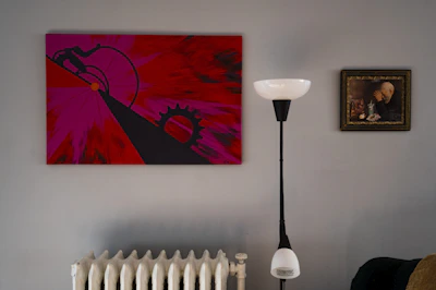 Close-up of a vibrant decorative print hanging in a minimalist urban apartment.