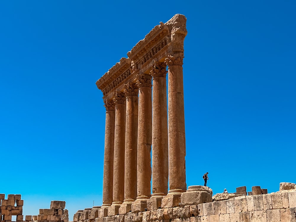 a man standing on top of a stone structure