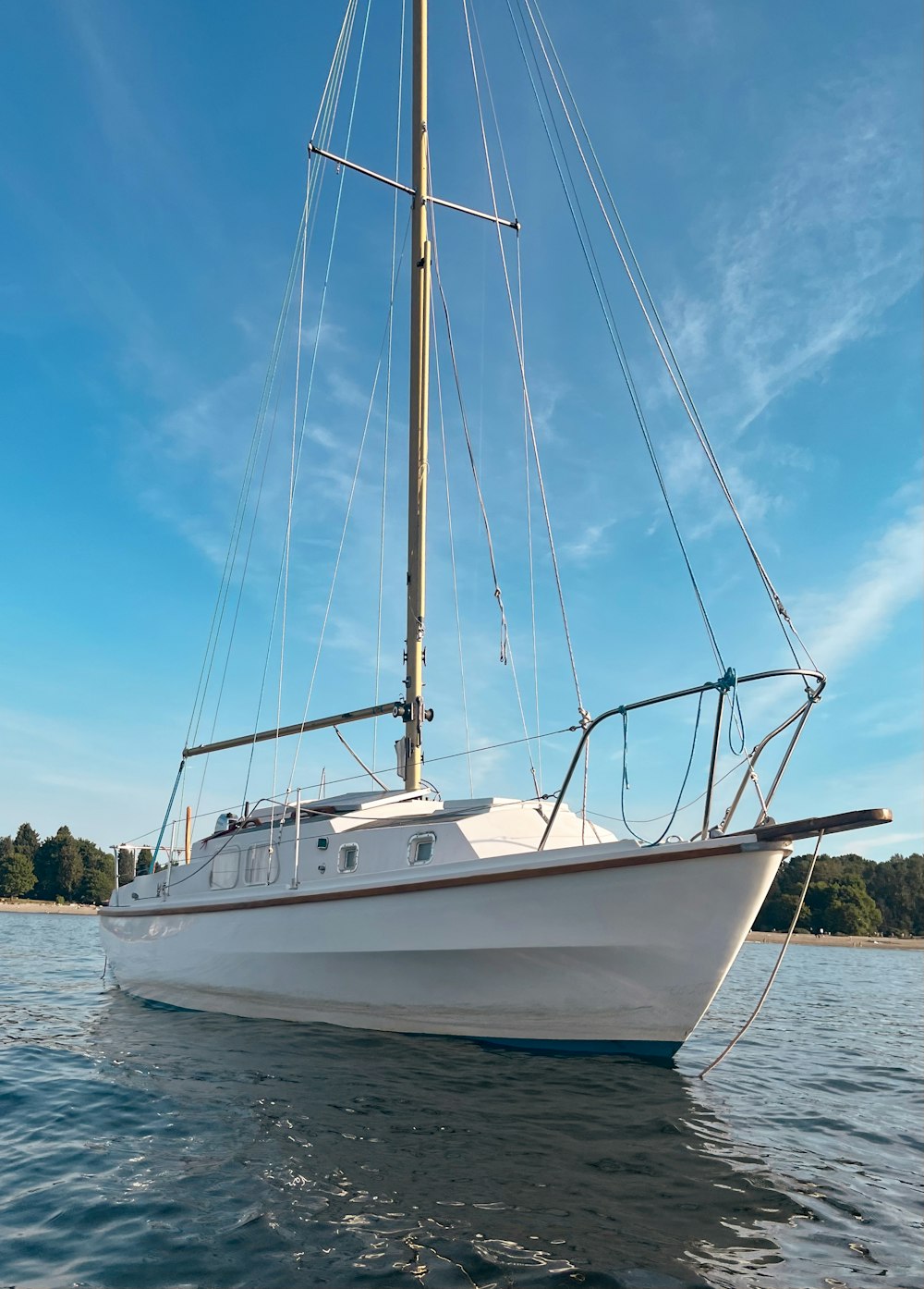 a white sailboat floating on top of a body of water