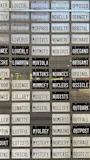 Array of traditional number plates lined up on a wooden display rack