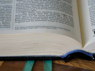 A spread showing the interlinear Hebrew text alongside English transliteration and detailed footnotes.