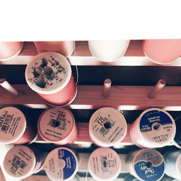 Spools of spunlex threads stacked in a clean, organized warehouse.