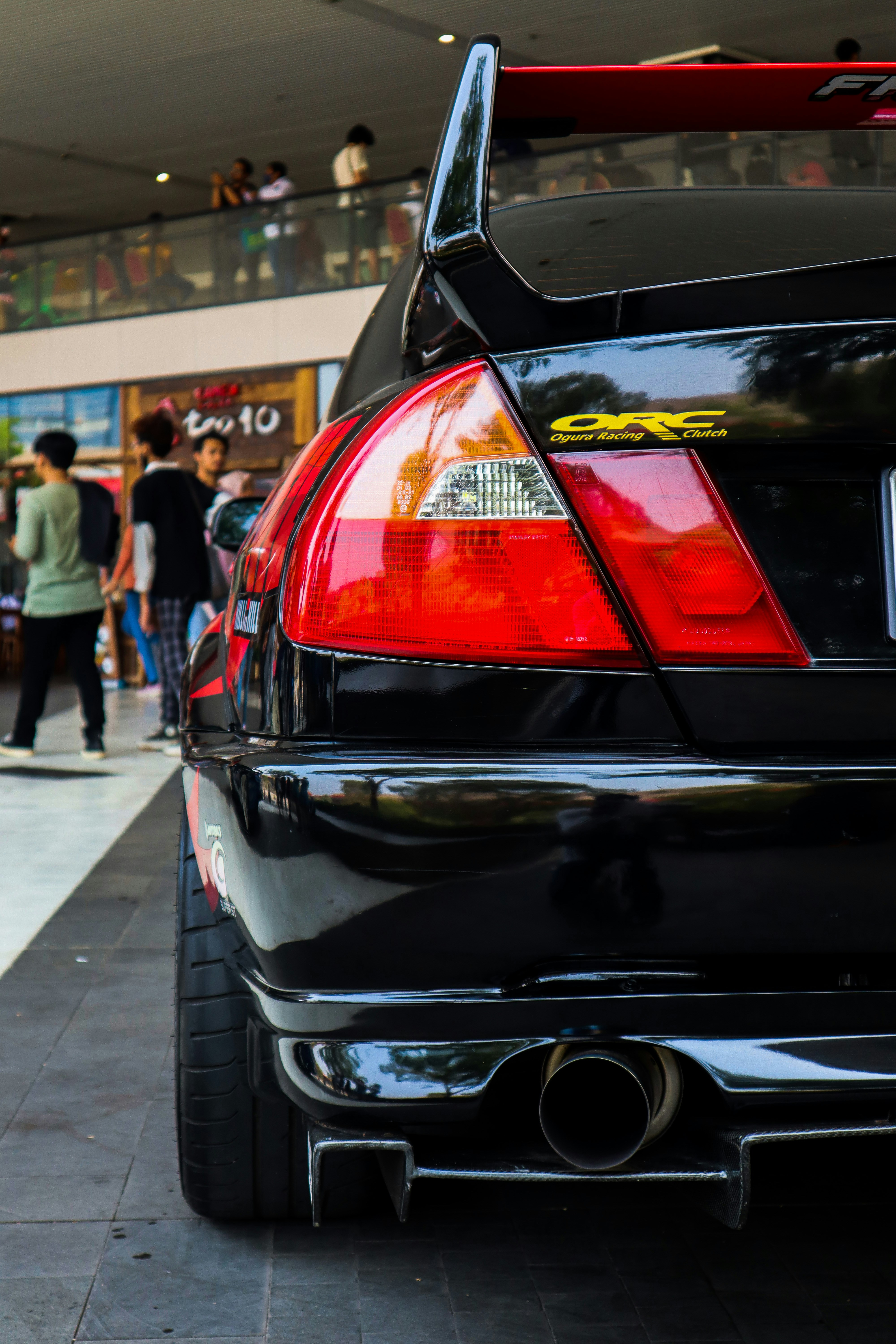 A black car parked in front of a building photo – Free Car Image on ...
