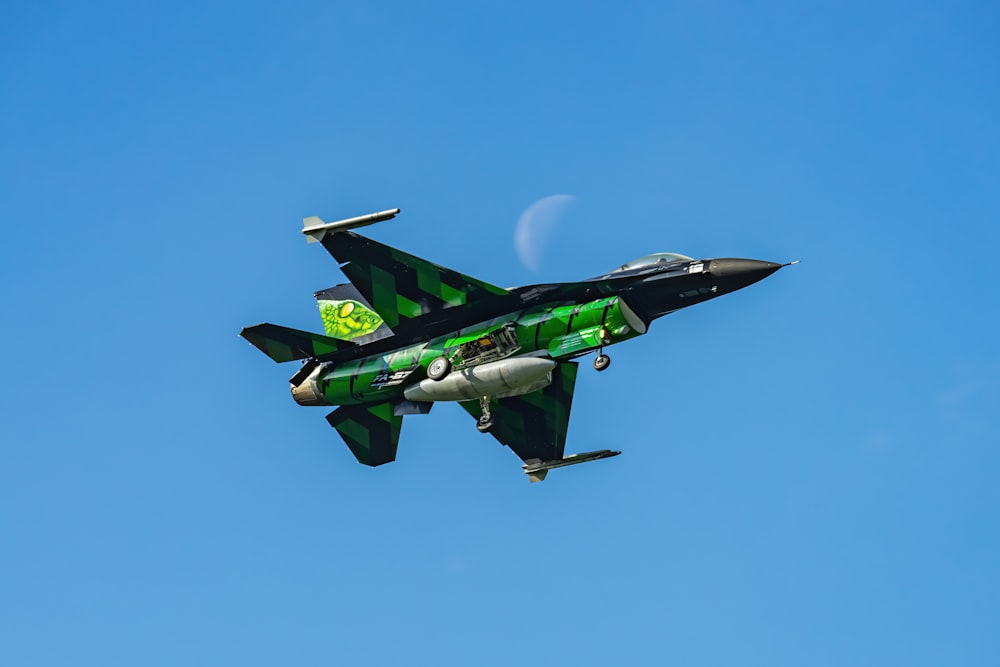 a fighter jet flying through a blue sky