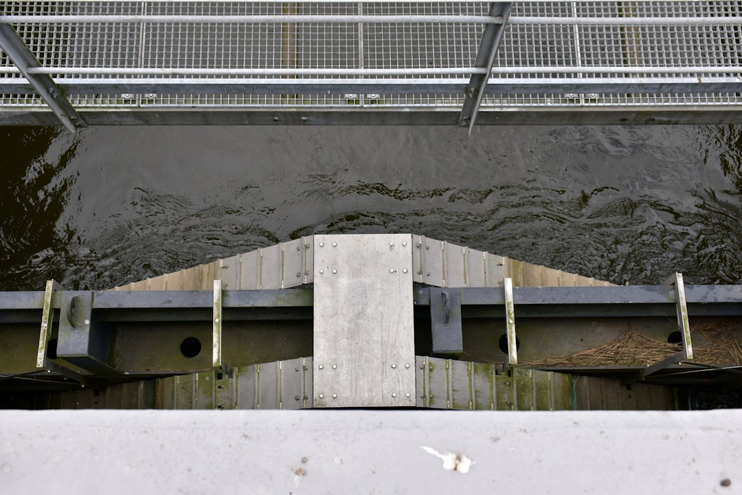 a view of a bridge over a body of water, A footbridge at a lock (Almost art)