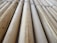 A close-up view of several bamboo sticks arranged parallel to each other, displaying a range of light brown and beige shades with visible natural textures and grains.