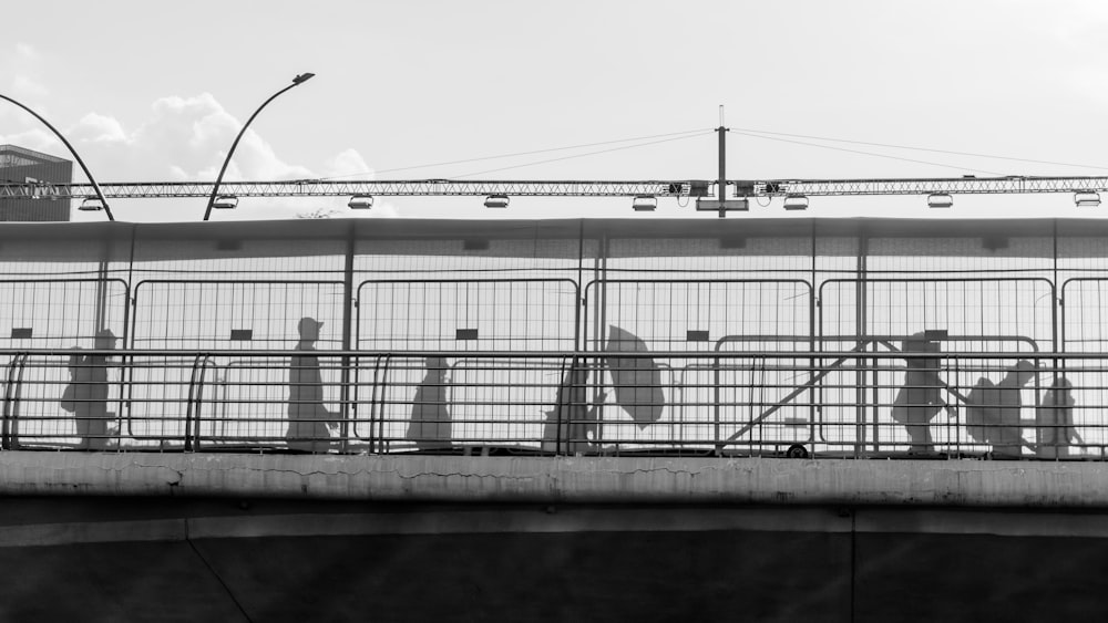 a group of people walking across a bridge