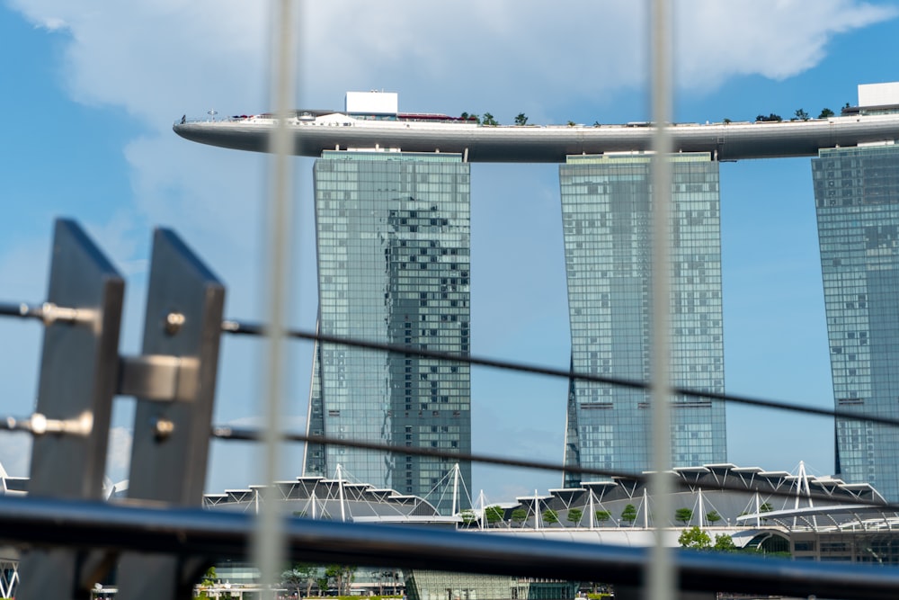 a view of some very tall buildings through a fence