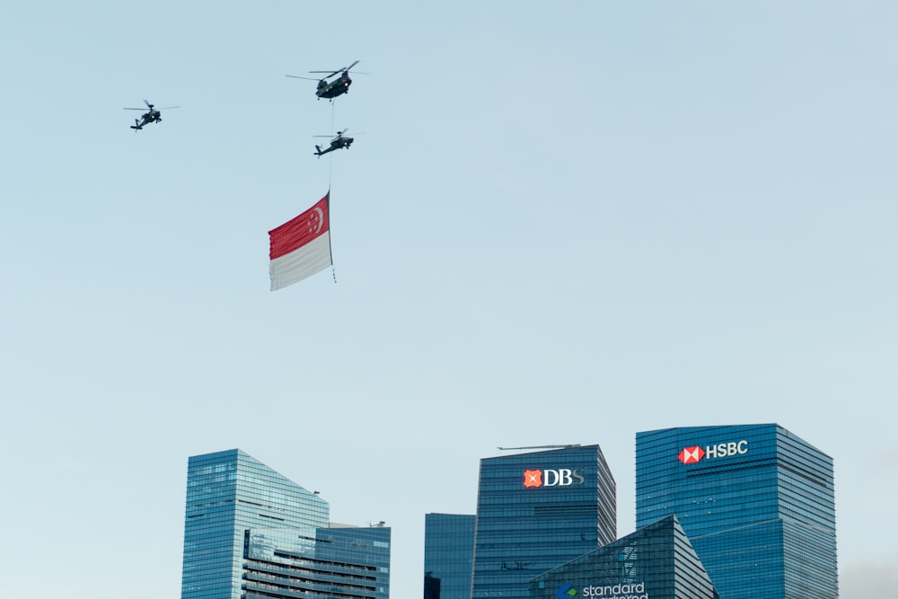 a group of military helicopters flying over a city