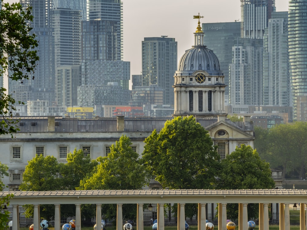 a large building with a clock tower in the middle of a city