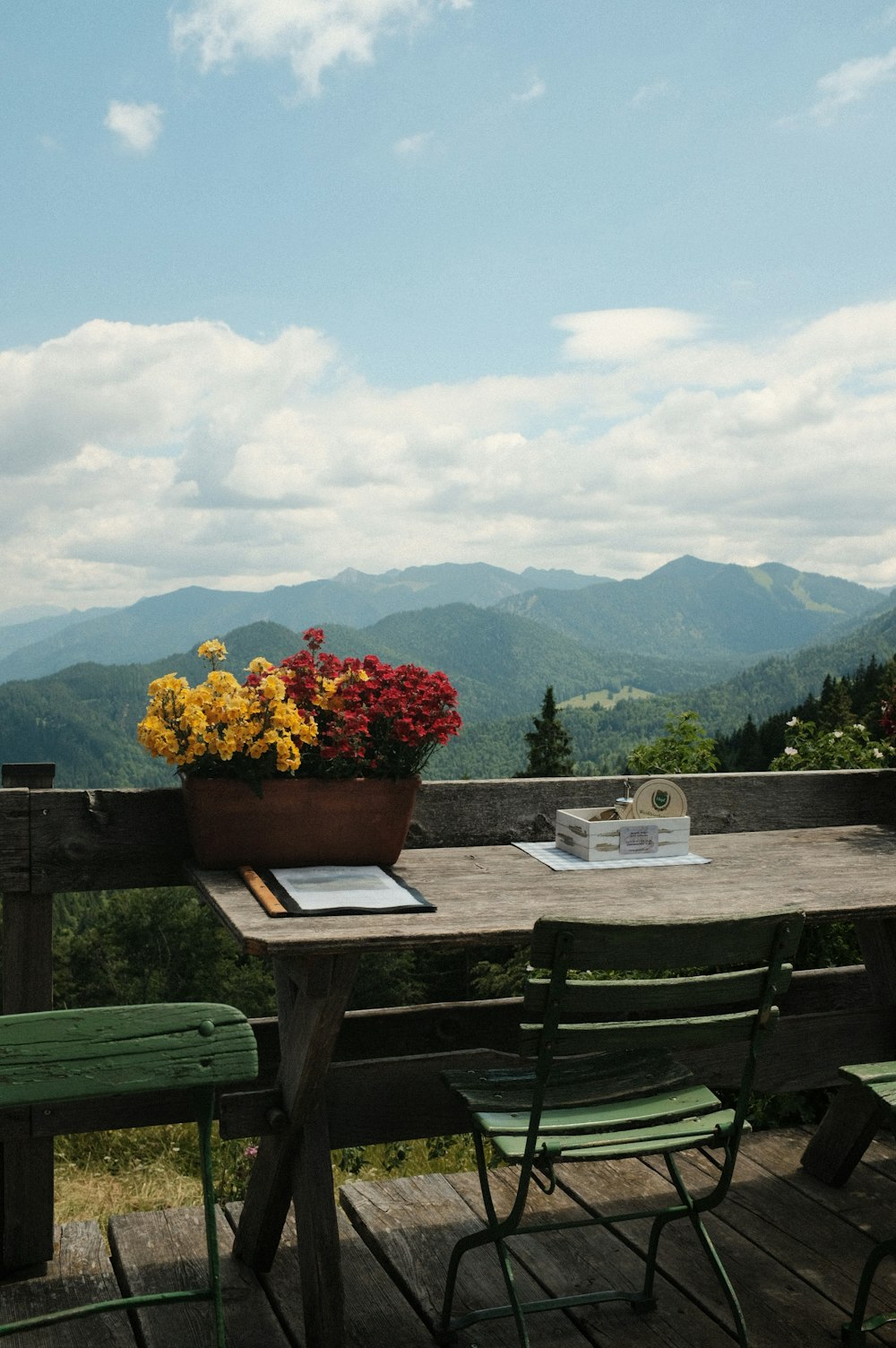 a wooden table topped with a pot of flowers