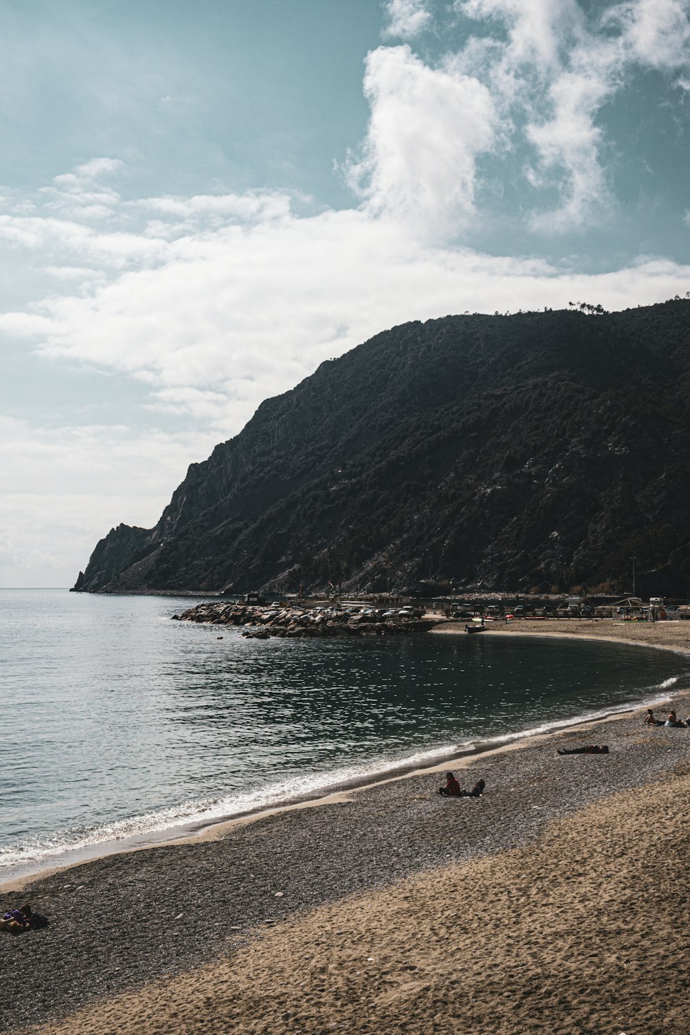 a group of people laying on top of a sandy beach