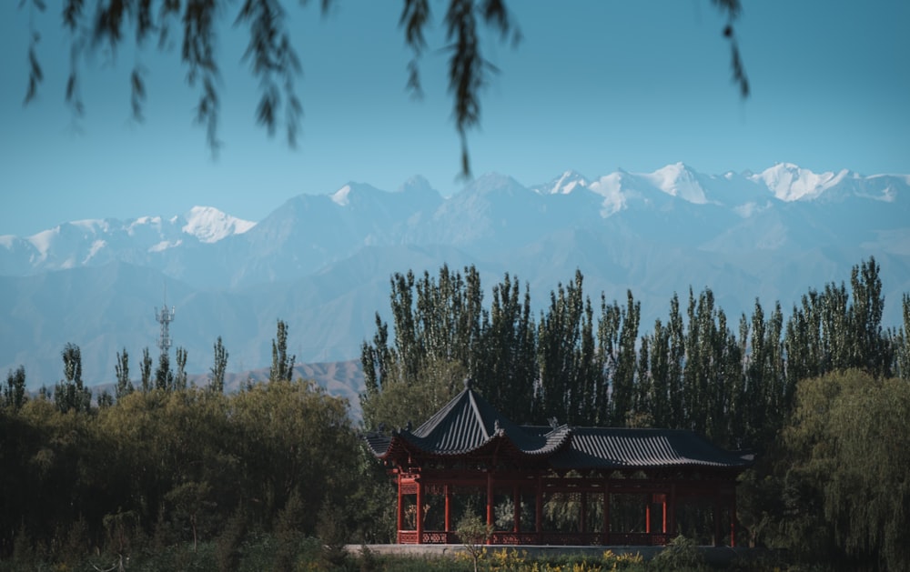 a gazebo with mountains in the background