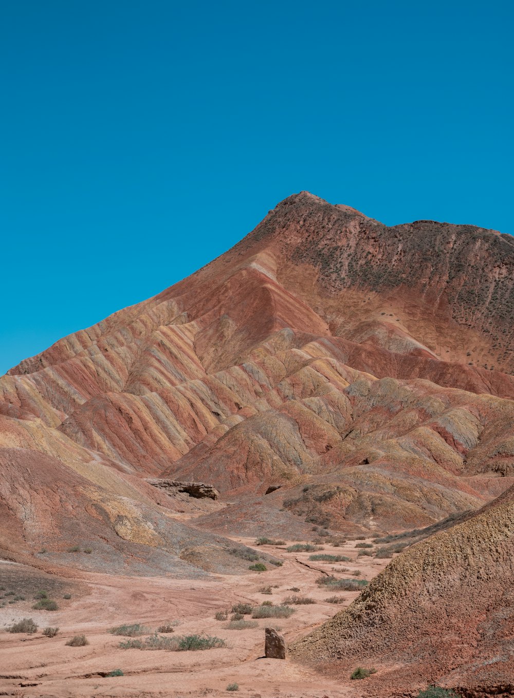 a mountain with a small hut in the middle of it