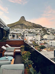 Rooftop terrace with panoramic views of the city and mountains.
