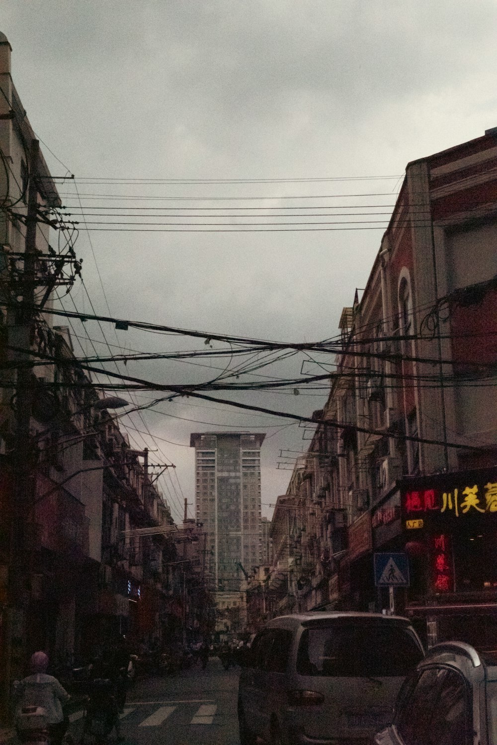 a city street filled with traffic next to tall buildings