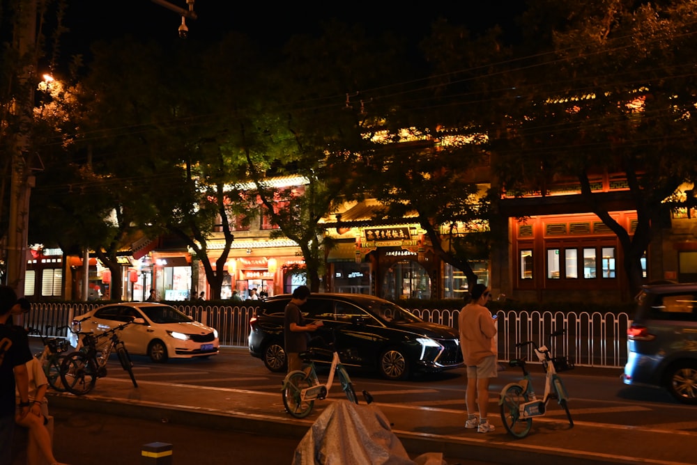 a city street at night with cars and people