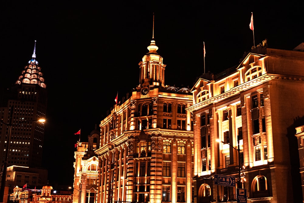 a large building with a clock tower at night